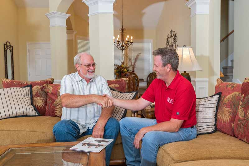 dealer and customer on couch